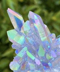 a cluster of crystals on top of a piece of wood